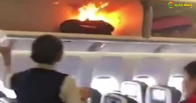 Hand luggage bursts into flames on busy flight as hero air steward tackles the blaze with mineral water